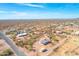 Aerial view of a rural Arizona property with desert landscaping, horse area, and a view of the mountains at 4188 N Plaza Dr, Apache Junction, AZ 85120