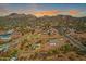 Breathtaking aerial view of the desert community with mountain views at sunset at 4188 N Plaza Dr, Apache Junction, AZ 85120