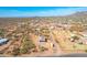 Aerial shot of desert home with horse property, featuring ample land, mountain views and blue Arizona skies at 4188 N Plaza Dr, Apache Junction, AZ 85120