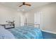 Cozy bedroom featuring a ceiling fan and vibrant blue patterned bedding at 4188 N Plaza Dr, Apache Junction, AZ 85120