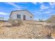 View of a home in a sparse landscape, showing the tan ground and desert shrubs at 4188 N Plaza Dr, Apache Junction, AZ 85120