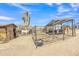 Rural horse property with covered stalls, fencing, and room to roam under a vast Arizona sky at 4188 N Plaza Dr, Apache Junction, AZ 85120