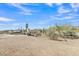 Expansive horse property with metal pipe fencing and ample space to roam under vast Arizona skies at 4188 N Plaza Dr, Apache Junction, AZ 85120