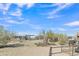 Spacious horse property featuring metal pipe fencing and ample space to roam under a blue Arizona sky at 4188 N Plaza Dr, Apache Junction, AZ 85120