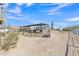 Expansive horse property featuring covered stalls, fencing, and ample space to roam under blue Arizona skies at 4188 N Plaza Dr, Apache Junction, AZ 85120