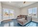 Cozy living room featuring a large window, a ceiling fan, and views through a large sliding glass door at 4188 N Plaza Dr, Apache Junction, AZ 85120