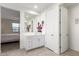 Bathroom view with a white vanity, large mirror, and an open doorway to the primary bedroom at 4459 E Warlander Ln, San Tan Valley, AZ 85140