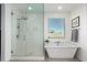 Bathroom featuring a glass enclosed walk-in shower, a soaking tub, and a large window at 4459 E Warlander Ln, San Tan Valley, AZ 85140