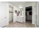 Bright white bathroom featuring a double vanity, a walk-in closet, and a glass-enclosed shower at 4459 E Warlander Ln, San Tan Valley, AZ 85140