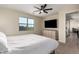 Neutral bedroom featuring a large window, ceiling fan, and a dresser with drawers at 4459 E Warlander Ln, San Tan Valley, AZ 85140