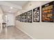 Bright hallway with tile flooring, decorated with automotive artwork leading to the front door and beyond at 4459 E Warlander Ln, San Tan Valley, AZ 85140