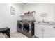 Well-equipped laundry room with gray washer and dryer, utility sink and extra storage at 4459 E Warlander Ln, San Tan Valley, AZ 85140