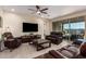 Bright living room with tile floors and sliding glass doors leading to a covered patio and outdoor seating area at 4459 E Warlander Ln, San Tan Valley, AZ 85140