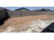 Spacious backyard featuring a block wall for added privacy and a dirt surface, ready for landscaping at 46886 W Old Timer Rd, Maricopa, AZ 85139