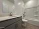 Clean bathroom featuring modern vanity, a shower-tub combo and tile flooring at 46886 W Old Timer Rd, Maricopa, AZ 85139