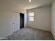 Cozy bedroom features sliding closet doors, a window, and soft carpeting at 46886 W Old Timer Rd, Maricopa, AZ 85139