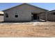 Home exterior showcasing stucco siding, windows, and an open-air patio area at 46886 W Old Timer Rd, Maricopa, AZ 85139