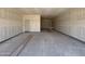 Unfinished two-car garage with concrete floors, drywall, and ample space at 46886 W Old Timer Rd, Maricopa, AZ 85139