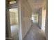 Hallway with newly installed drywall that leads to a living space with natural light at 46886 W Old Timer Rd, Maricopa, AZ 85139
