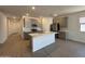 Open-concept kitchen featuring a spacious island, modern appliances, and tile flooring at 46886 W Old Timer Rd, Maricopa, AZ 85139