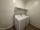Cozy laundry area featuring a shelf, tile flooring, and a full-sized washer and dryer at 46886 W Old Timer Rd, Maricopa, AZ 85139