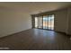 Spacious living room area featuring sliding glass doors to a patio and tile flooring at 46886 W Old Timer Rd, Maricopa, AZ 85139