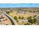 Stunning aerial view of a community nestled near a canal and park at 475 S Soho Ln # 35, Chandler, AZ 85225