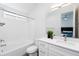 Modern bathroom with a tub, white cabinets, and a large mirror at 475 S Soho Ln # 35, Chandler, AZ 85225