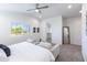 Light-filled bedroom featuring neutral decor, a ceiling fan, and large windows overlooking the outdoors at 475 S Soho Ln # 35, Chandler, AZ 85225