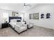 Bright bedroom featuring vaulted ceilings, a ceiling fan, and neutral-toned furniture at 475 S Soho Ln # 35, Chandler, AZ 85225