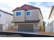 Modern two-story home with a gray garage door and colorful accents on upper story at 475 S Soho Ln # 35, Chandler, AZ 85225