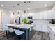 Modern kitchen island featuring white countertops, barstool seating, and pendant lighting at 475 S Soho Ln # 35, Chandler, AZ 85225