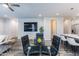 Open-concept dining area with glass table, leather chairs, and neutral color palette at 475 S Soho Ln # 35, Chandler, AZ 85225