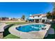 Beautiful backyard featuring a sparkling pool, lush lawn, and a patio area perfect for outdoor entertaining at 5915 E Fairfield St, Mesa, AZ 85205