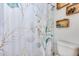 Bathroom featuring a decorative shower curtain, toilet, and shelving at 5915 E Fairfield St, Mesa, AZ 85205