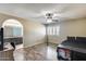 Spacious bedroom with a fan and modern floors, adjoining bath and minimalist decor at 5915 E Fairfield St, Mesa, AZ 85205