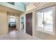 Bright entryway featuring tile flooring, dark wood door, and views into the bedroom and laundry room at 5915 E Fairfield St, Mesa, AZ 85205