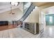 Bright entryway featuring a staircase with dark wood railings, a glass cabinet, and tile flooring at 5915 E Fairfield St, Mesa, AZ 85205