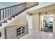 Inviting entryway features a staircase with dark wood railings and tile flooring, and access to a bedroom at 5915 E Fairfield St, Mesa, AZ 85205