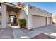 Charming home featuring a tiled roof, a three-car garage, and desert landscaping at 5915 E Fairfield St, Mesa, AZ 85205