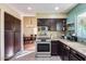 Functional kitchen with ample cabinet space and an adjacent dining area, perfect for Gathering meals at 5915 E Fairfield St, Mesa, AZ 85205