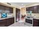 Efficient kitchen layout with plenty of storage and a view of the dining room, ideal for cooking at 5915 E Fairfield St, Mesa, AZ 85205