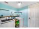 Well-lit laundry room with modern washer and dryer, floating shelves, and fresh paint at 5915 E Fairfield St, Mesa, AZ 85205