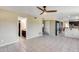 Open concept living room featuring neutral flooring, a ceiling fan, and access to the kitchen at 5915 E Fairfield St, Mesa, AZ 85205