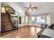 Bright living room featuring vaulted ceilings, hardwood floors, and a staircase at 5915 E Fairfield St, Mesa, AZ 85205