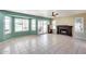 Spacious living room with fireplace, neutral tile flooring, and sliding glass doors to the patio at 5915 E Fairfield St, Mesa, AZ 85205