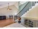 Open-concept living room with high ceilings, tile flooring, wood floors and staircase at 5915 E Fairfield St, Mesa, AZ 85205