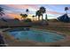 Inviting pool with palm trees in a private backyard oasis at 5915 E Fairfield St, Mesa, AZ 85205