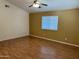 Bright bedroom with neutral walls, wood floors, a ceiling fan, and a large window at 614 W 7Th Ave, Mesa, AZ 85210