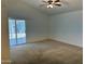 Spacious bedroom with ceiling fan and sliding door to the backyard at 614 W 7Th Ave, Mesa, AZ 85210